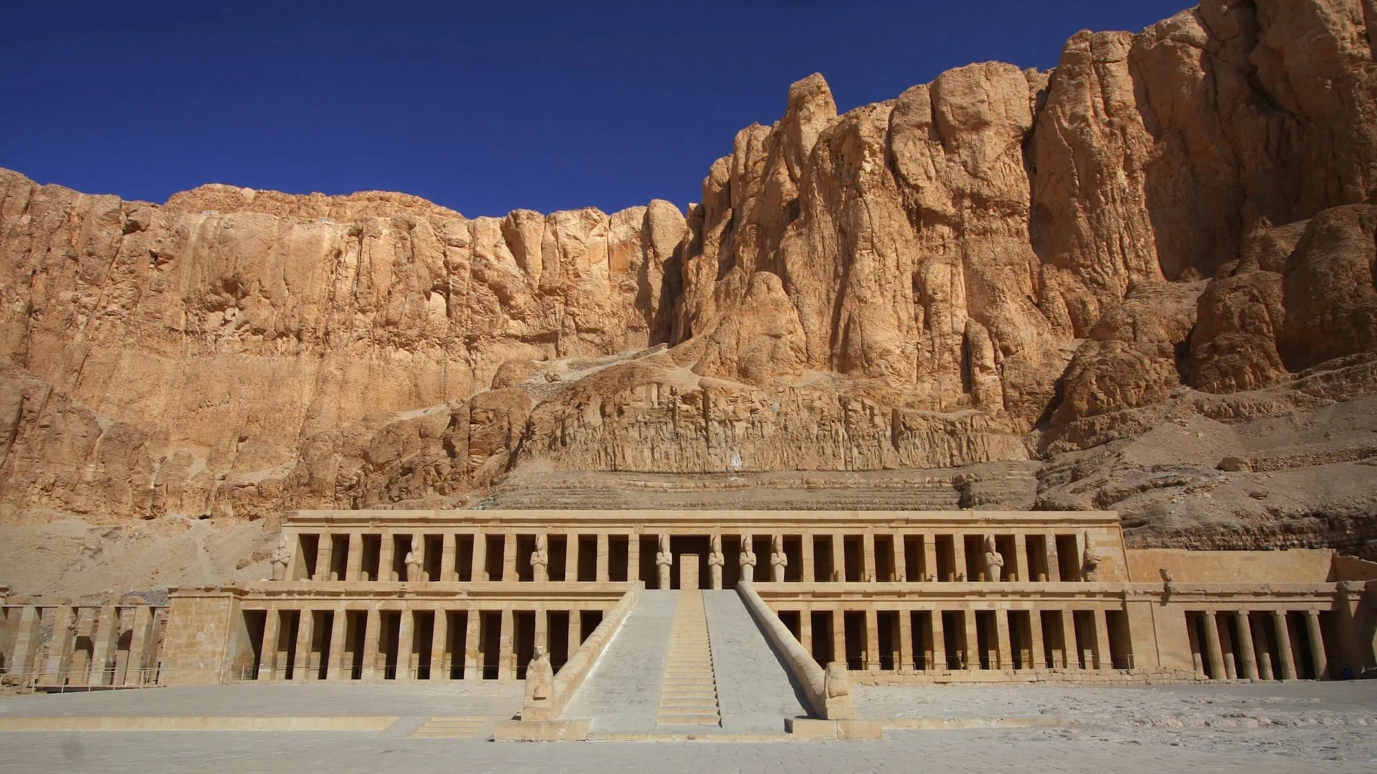 Queen Hatshepsut's mortuary temple carved into limestone cliffs at Deir el-Bahri