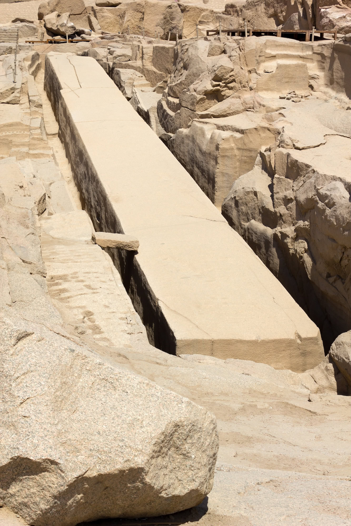 Ancient unfinished obelisk with visible structural cracks in granite quarry