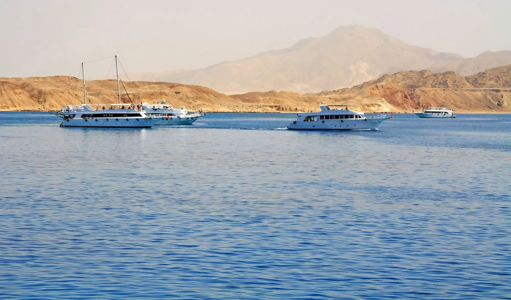 White yachts anchored in clear blue waters near Tiran Island