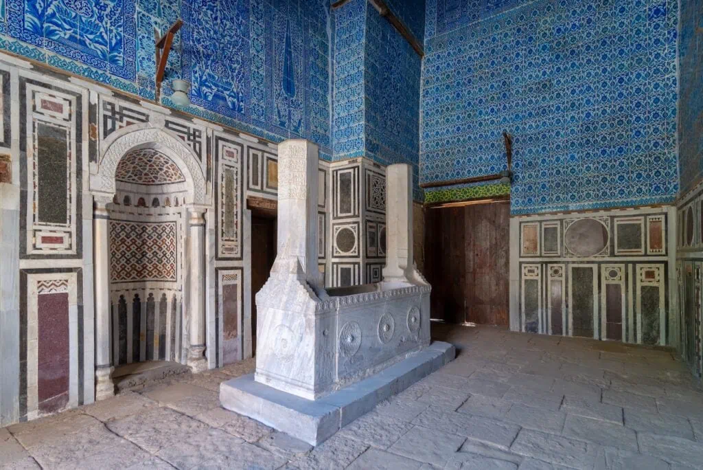 The domed tomb structure with stone walls and arched openings attached to the Aqsunqur Mosque in the Bab El Wazir district, Cairo