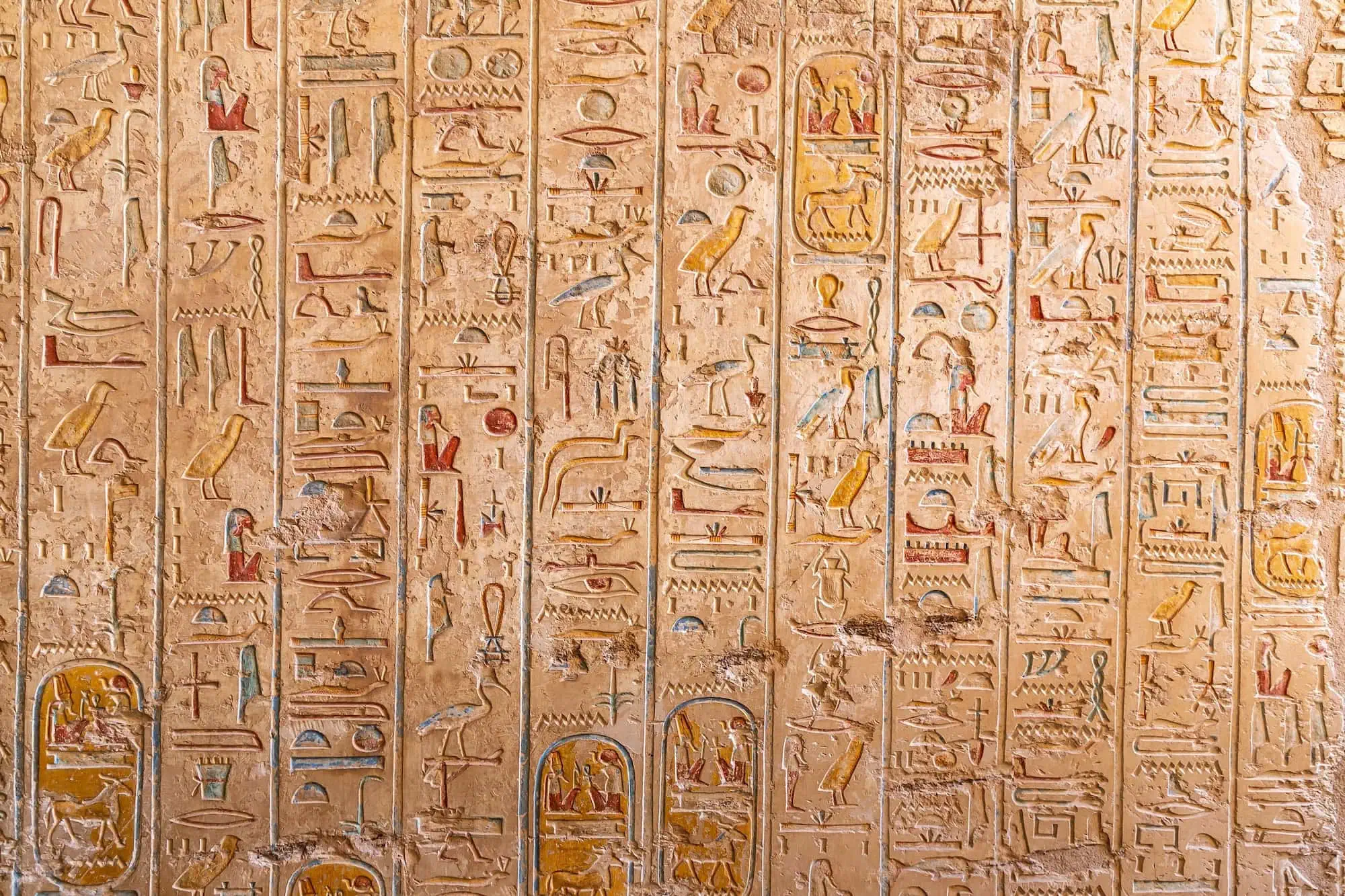 Ancient Egyptian hieroglyphic inscriptions on tomb walls in Valley of the Kings, Luxor