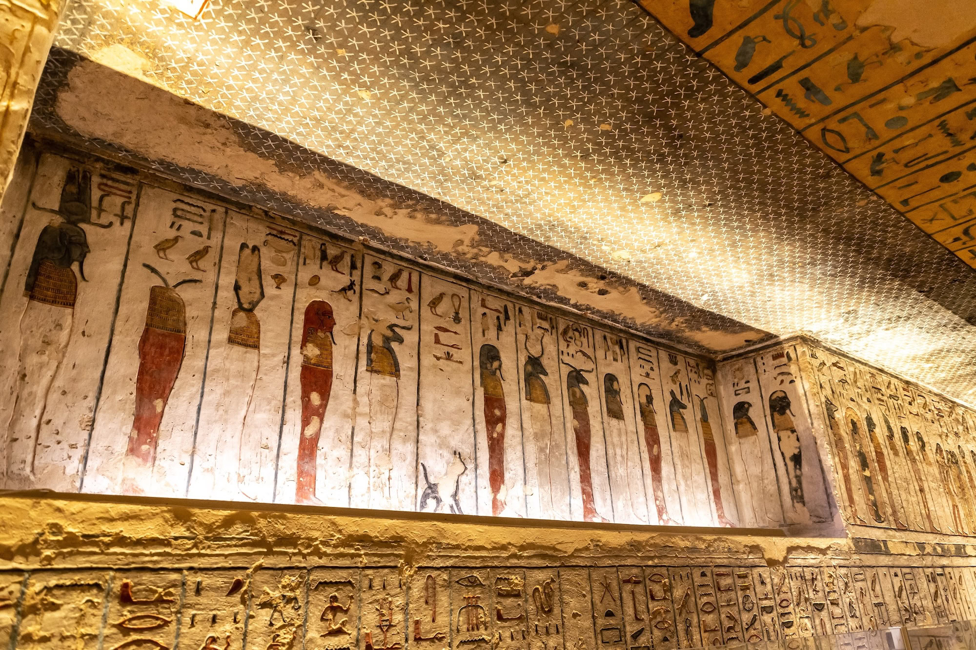 Interior of Ramesses III's tomb in the Valley of the Kings showing hieroglyphic wall paintings and star-decorated ceiling