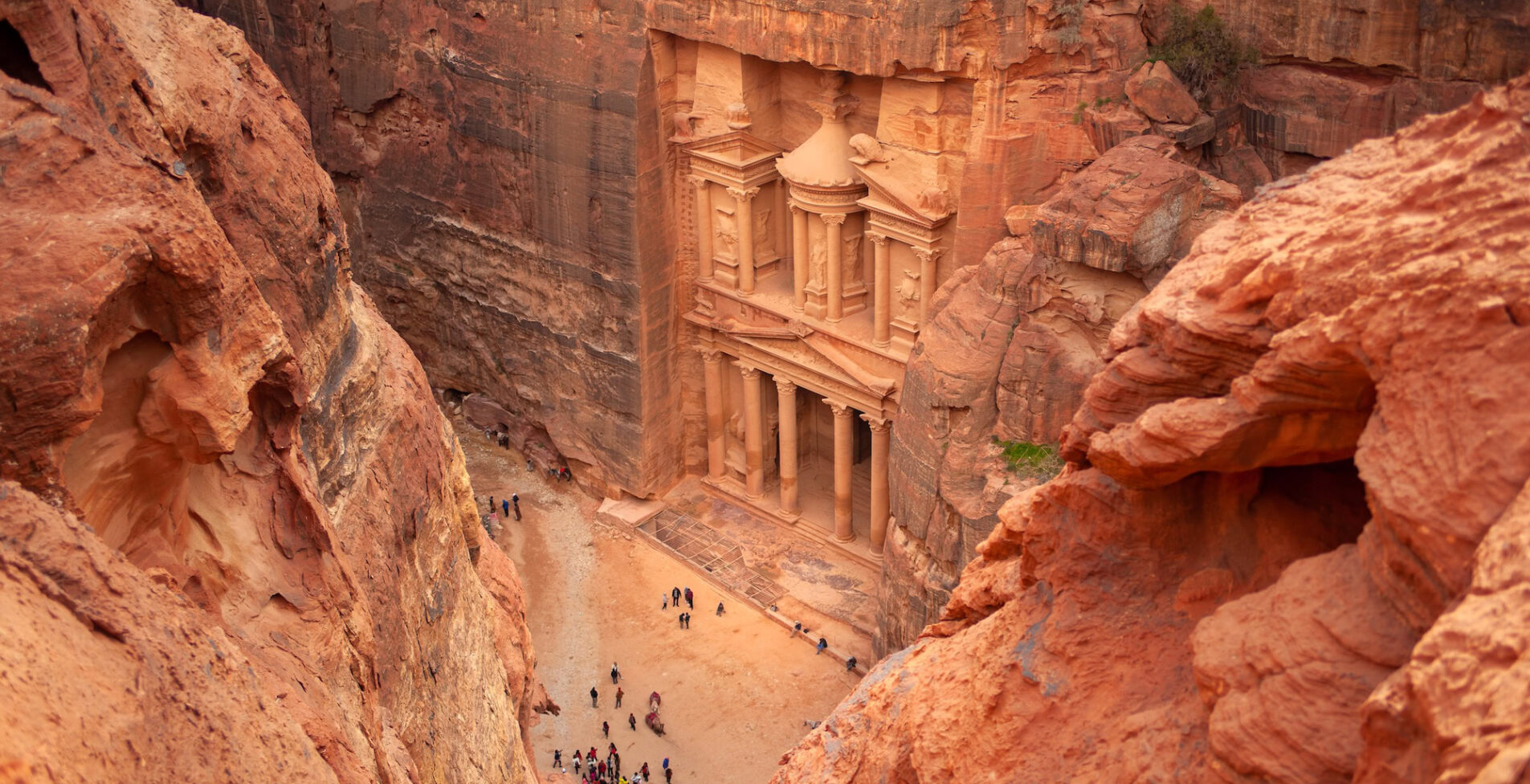 Top view of Al Khazneh the treasury ancient city of Petra Jordan. Nabatean rock cut temple of Hellenistic period of ancient Petra originally known to Nabataeans as Raqmu historical city 1905x976 crop 48 43