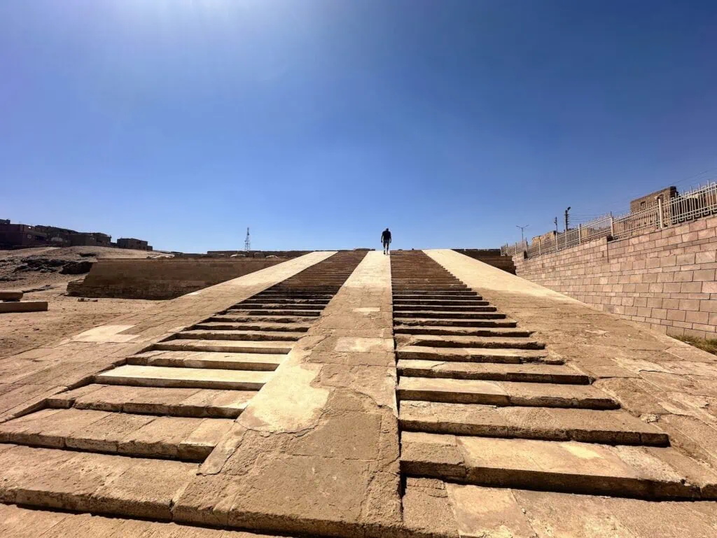 Tourist ascending the stone stairs leading to the Temple of Seti I at Abydos