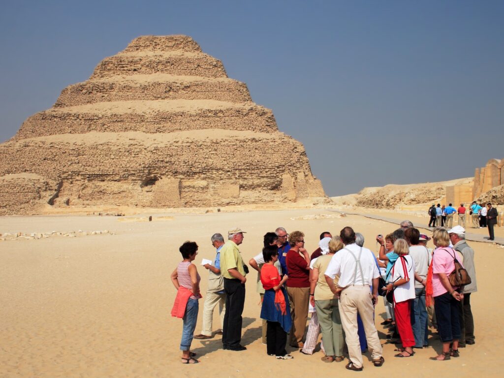 Tourists and Ancient step pyramid of Djoser (Zoser) at Saqqara, Egypt - Editorial