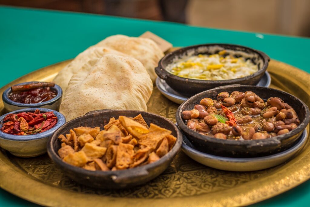 Traditional Upper Egypt breakfast featuring local bread, cheese, and side dishes on a shared table, Upper Egypt Cuisine, Luxor