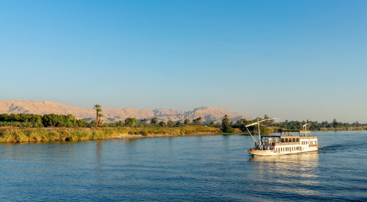Traditional Egyptian Dahabiya boat cruising on the Nile River