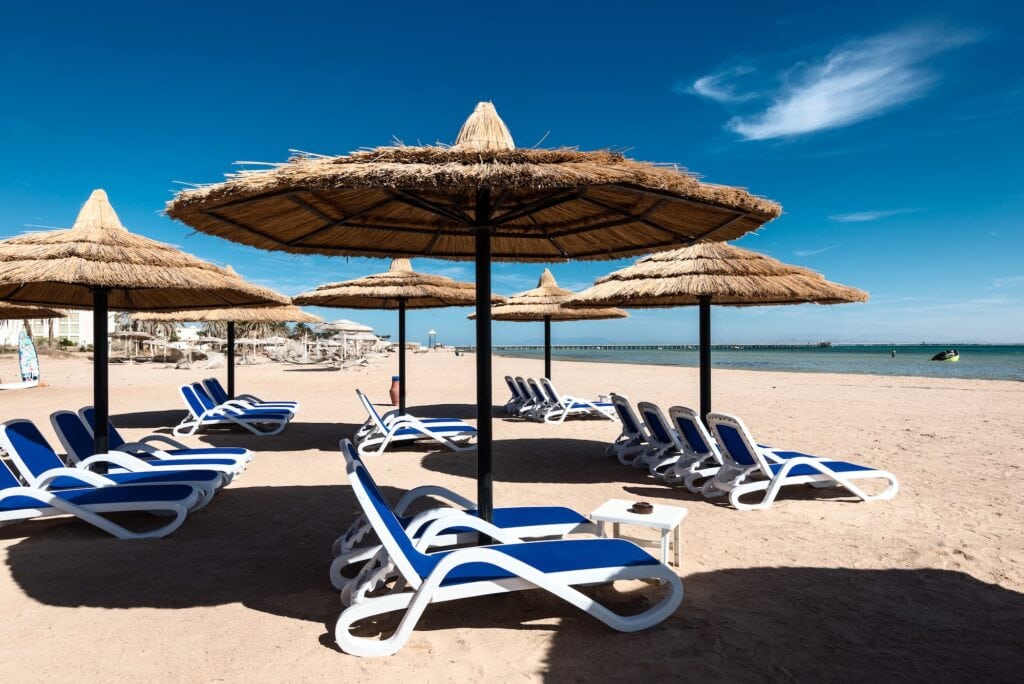 Beach umbrellas and sun loungers along the sandy shore of Nabq Bay, Sharm El Sheikh