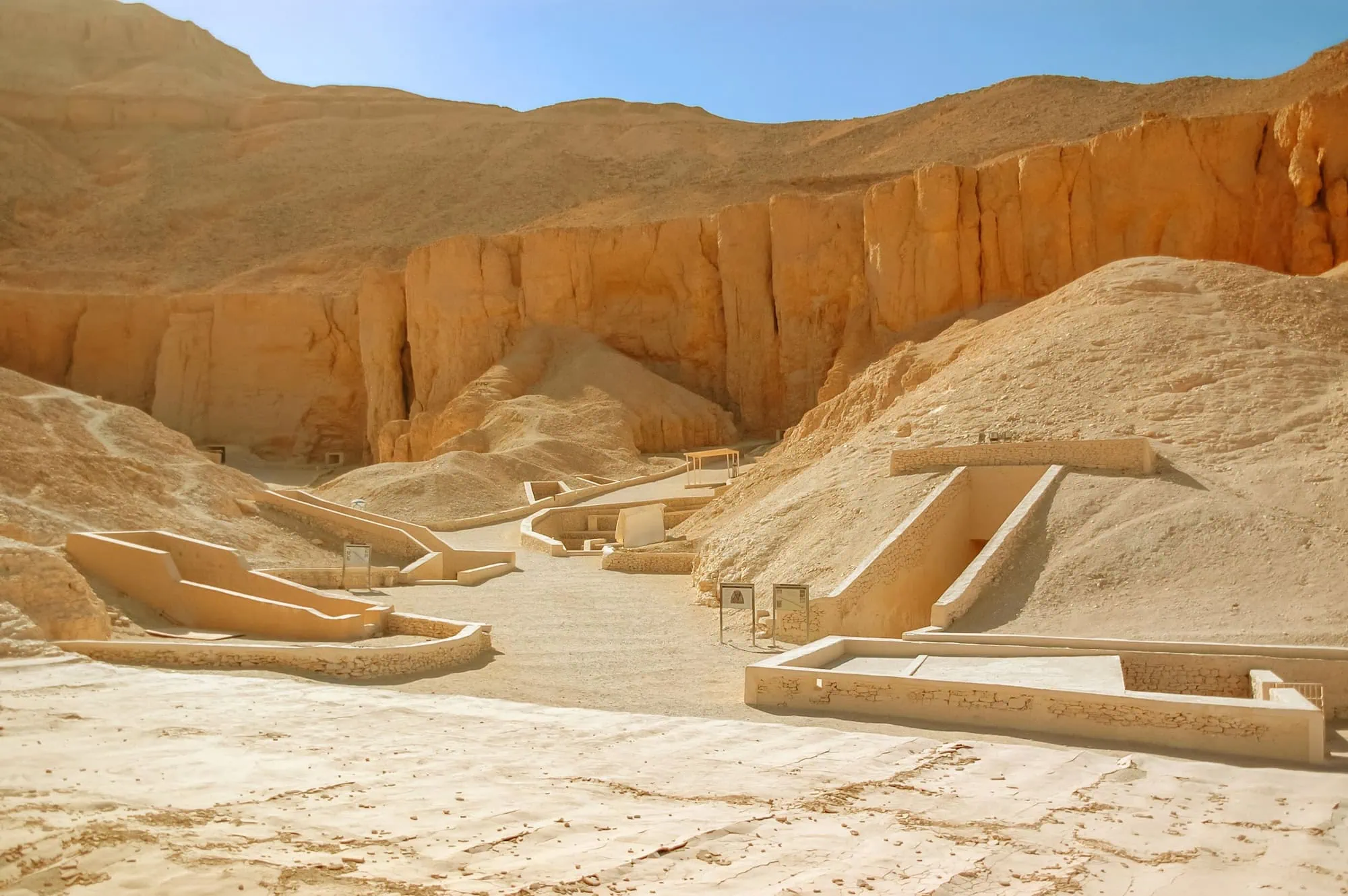 Tomb entrances carved into limestone cliffs in Valley of the Kings archaeological site