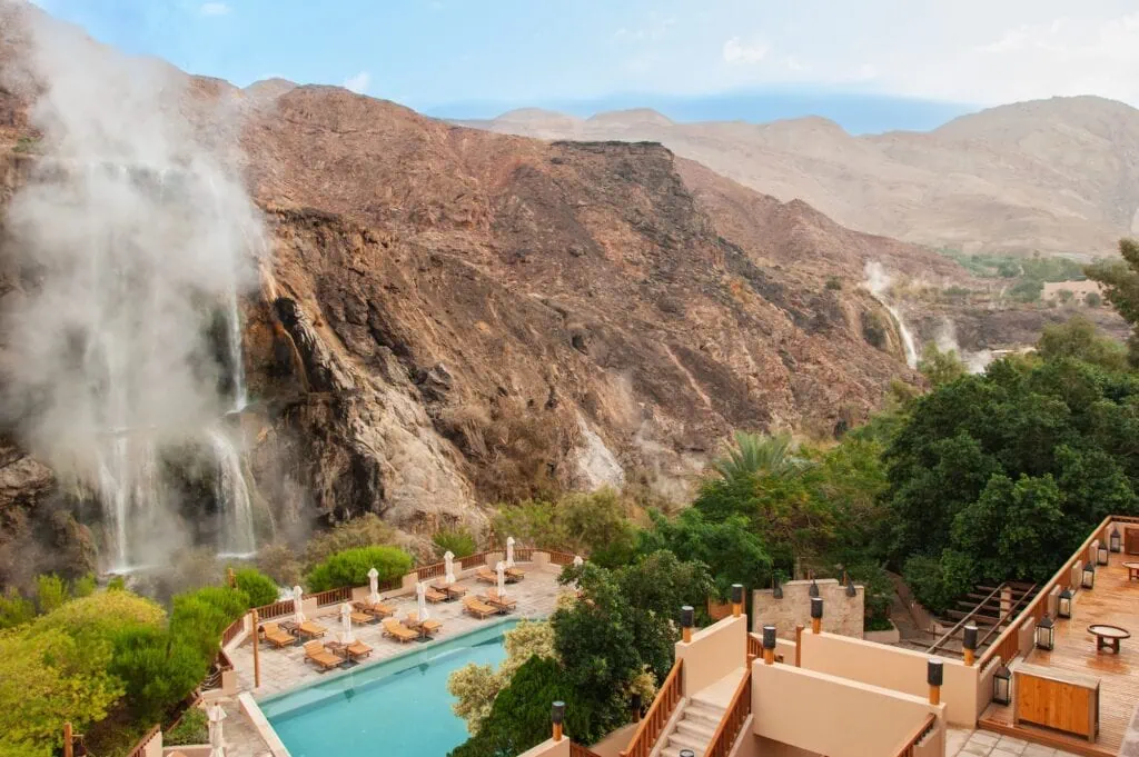Ma'in Hot Springs waterfalls and steam rising from thermal pools viewed from a spa hotel, Madaba