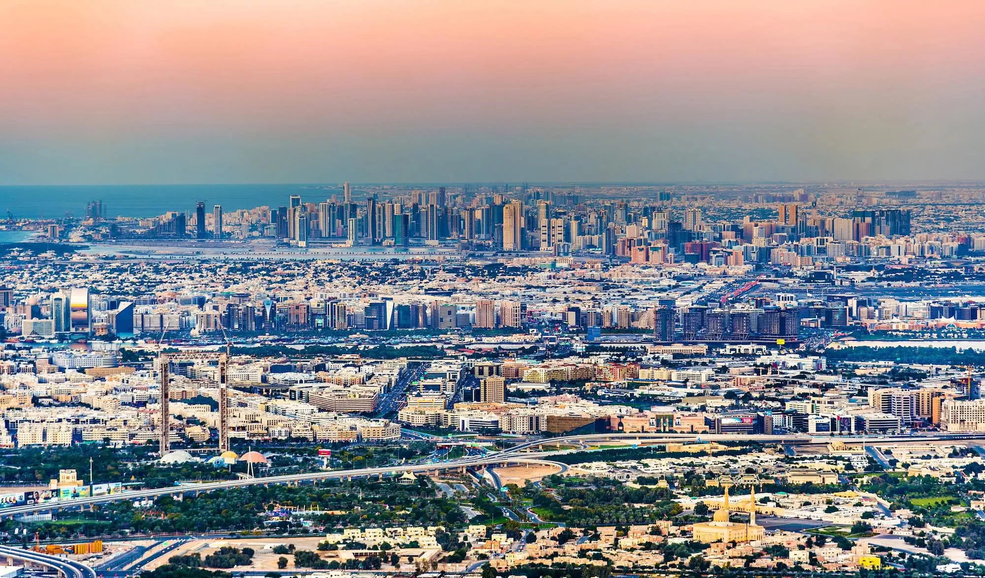 Aerial view of Dubai Creek and urban development during golden hour