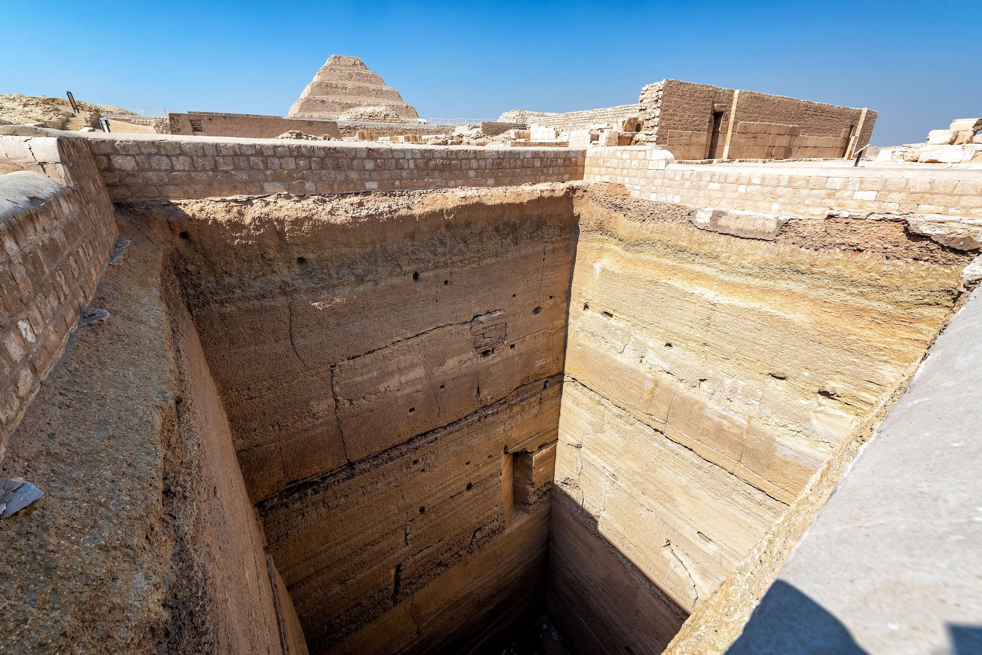 Excavated chambers and stone walls within the Step Pyramid complex at Saqqara