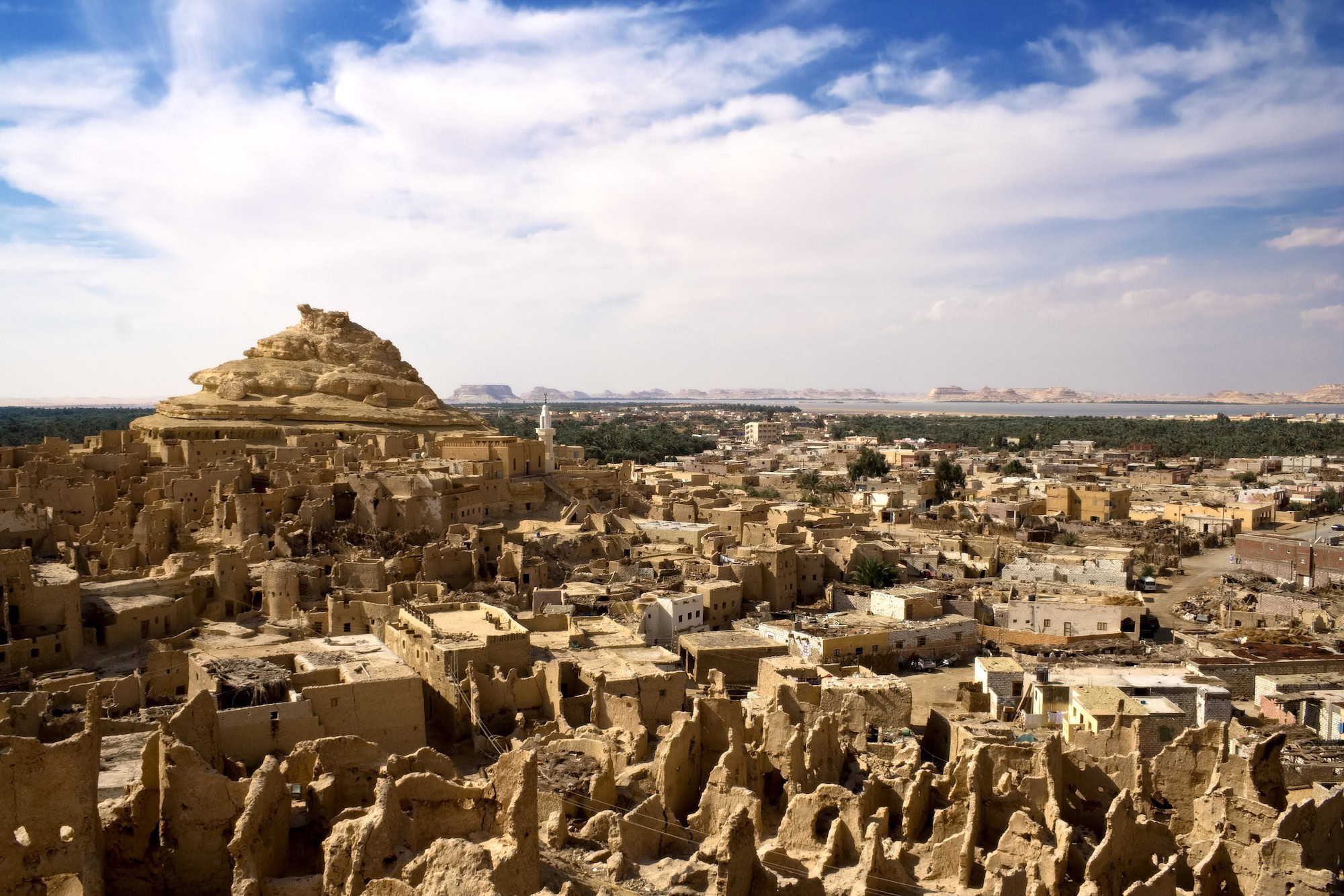 Panoramic view of Al Kharga city and surrounding desert landscape from an elevated temple position