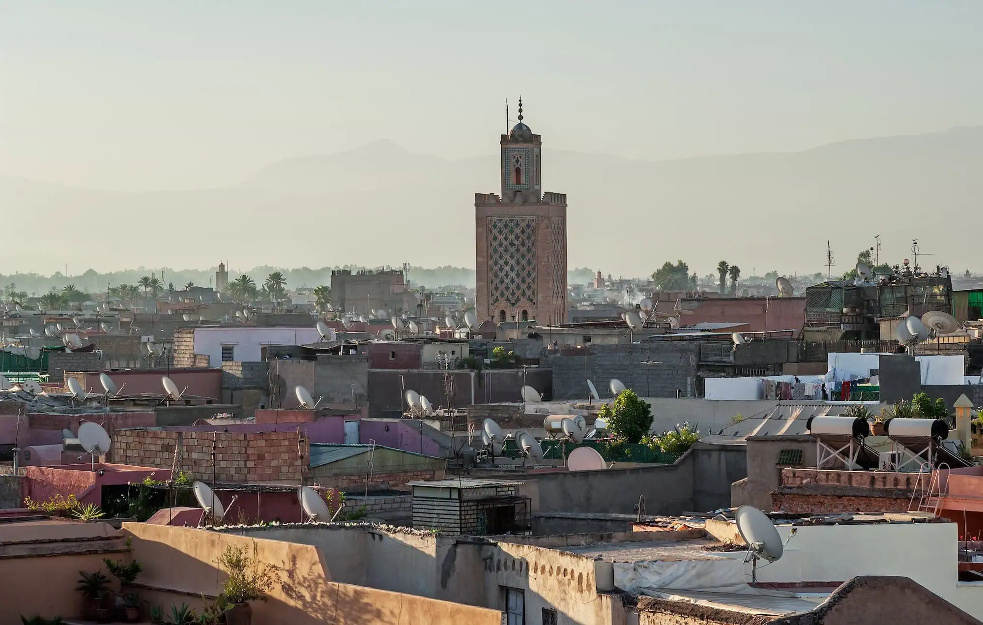 Panoramic view of Marrakech old town with traditional architecture and minaret at sunrise