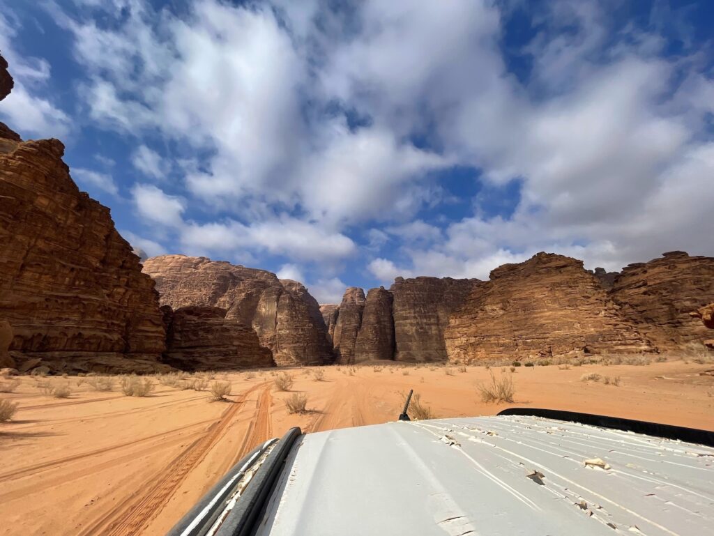 Four-wheel-drive vehicle traveling across Wadi Rum, Jordan
