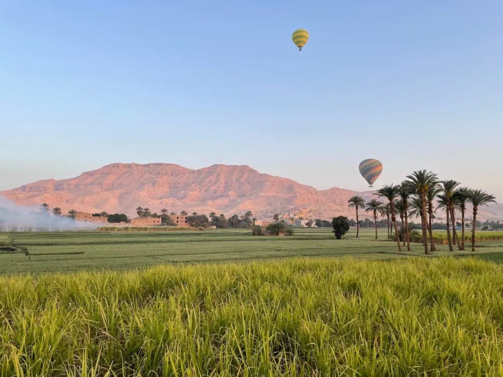 Green fields with rocky cliffs of the Valley of the Kings
