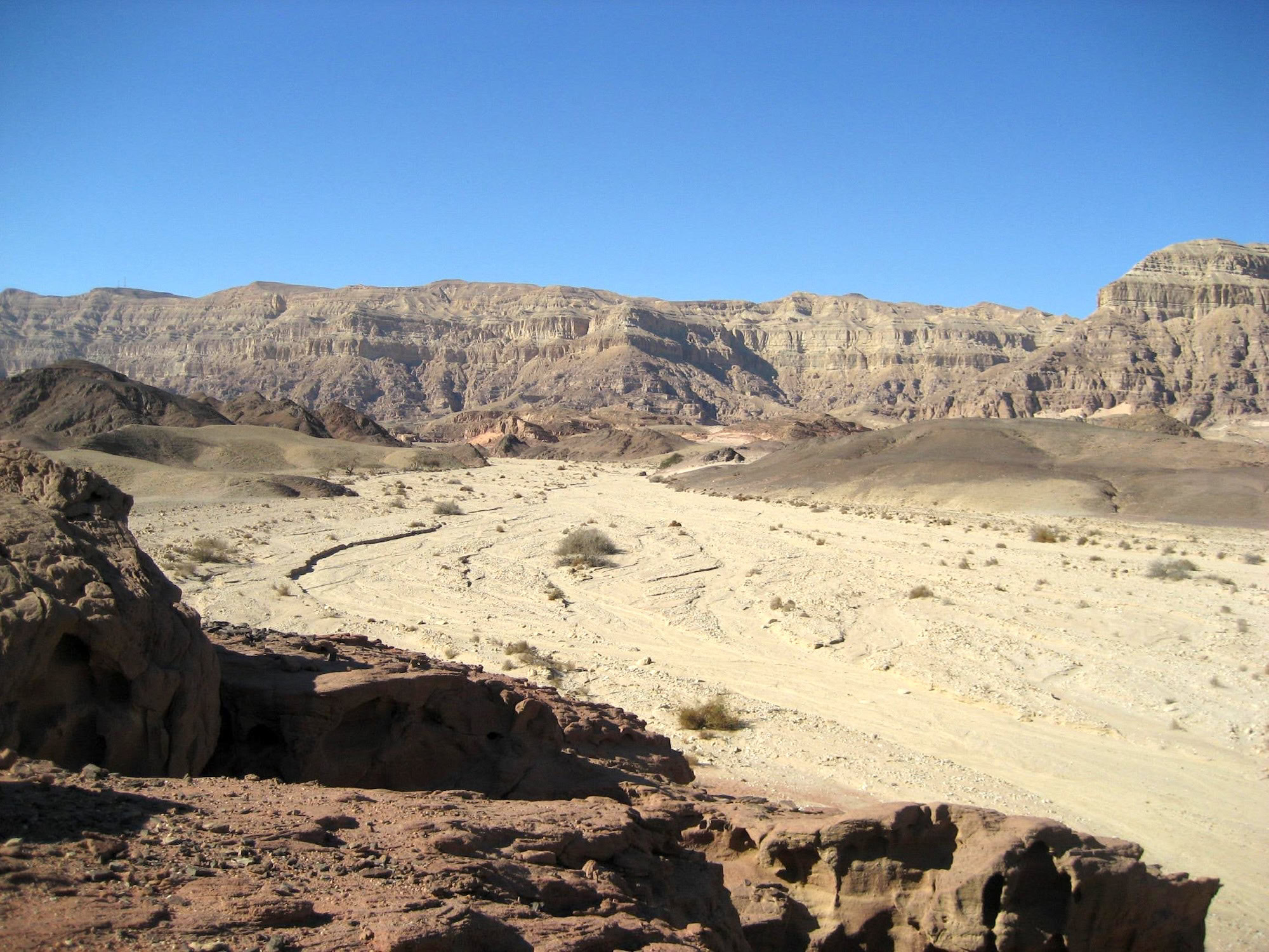 Barren desert landscape of the Judean Desert in Israel with layered rock formations