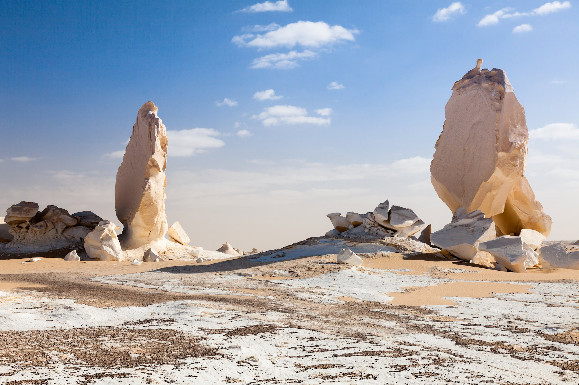 White limestone formations rising from desert floor in Egypt's White Desert