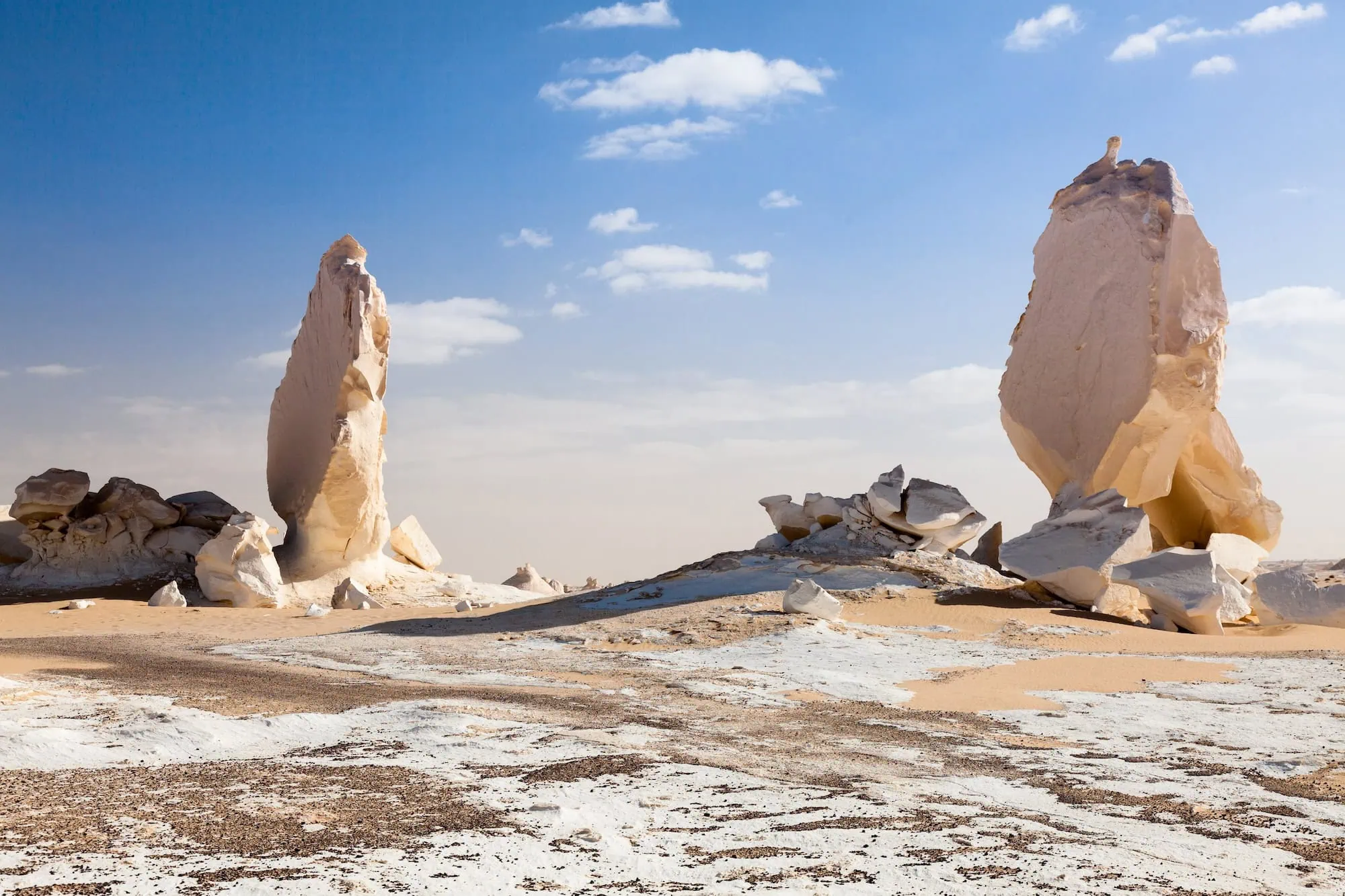 White limestone formations rising from desert floor in Egypt's White Desert