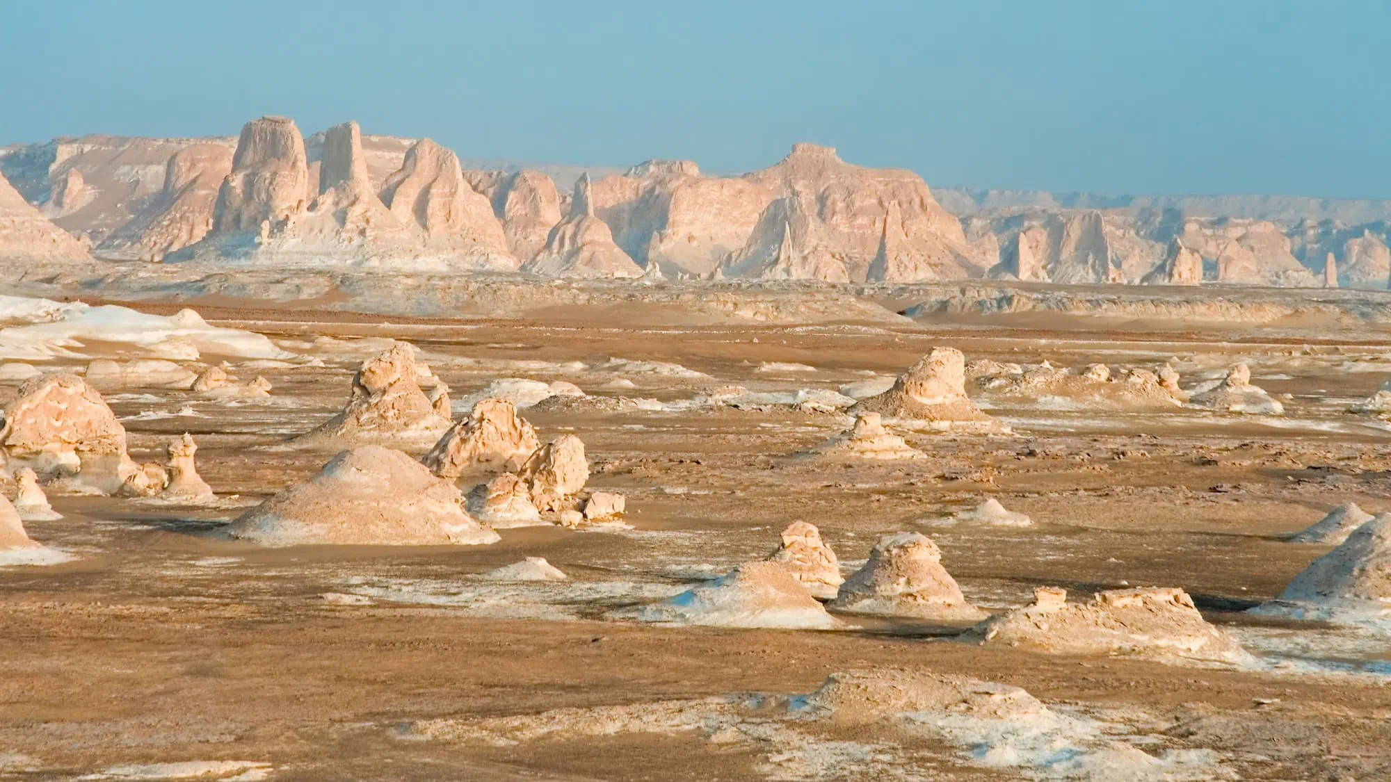 White limestone formations in Egypt's White Desert with dramatic sculptural rock shapes