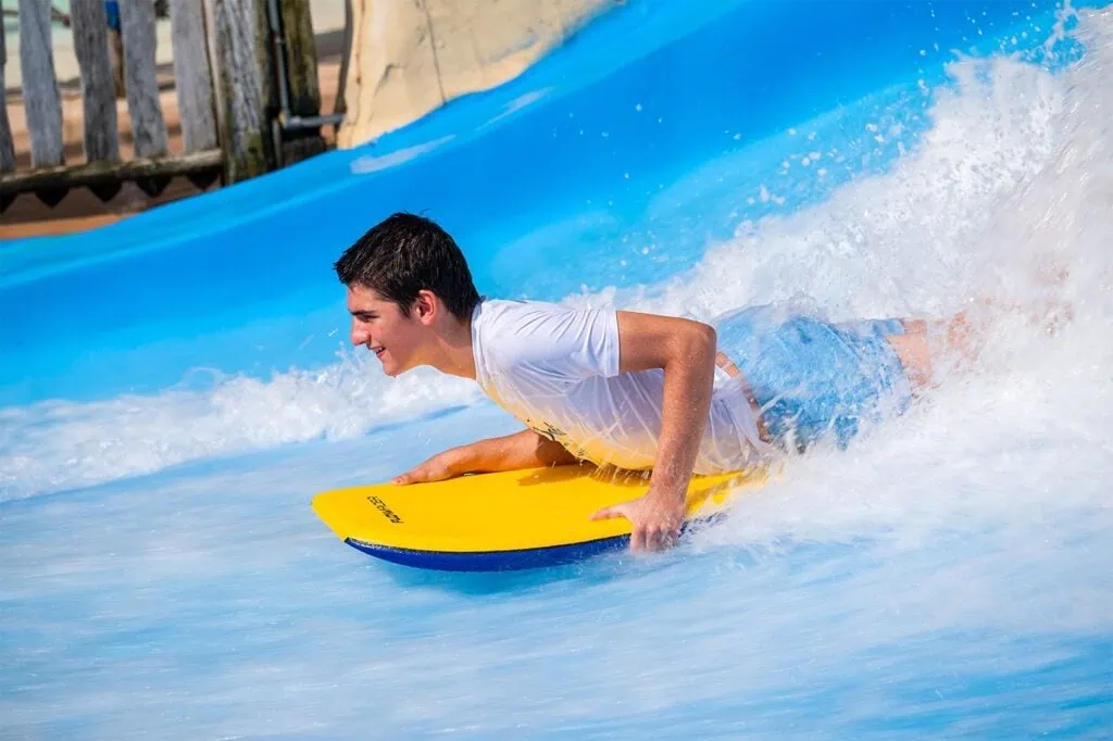 Boy riding a flowboard on an artificial wave at Wild Wadi Water Park Dubai