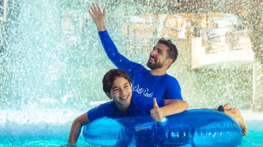 Father and son together in a shallow pool at Wild Wadi Water Park Dubai