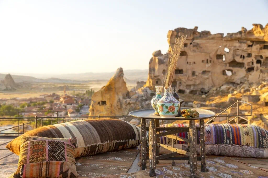 Cavusin restaurant terrace with stone seating, tables, and views over rock formations in Nevsehir City