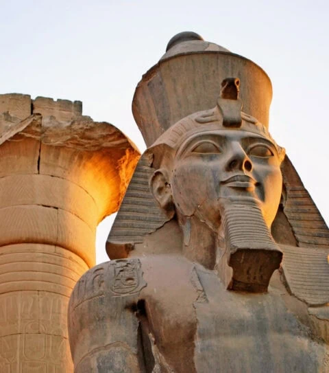 ancient Pharaoh statue and column on backlighted sky background 480x543 crop 31 79