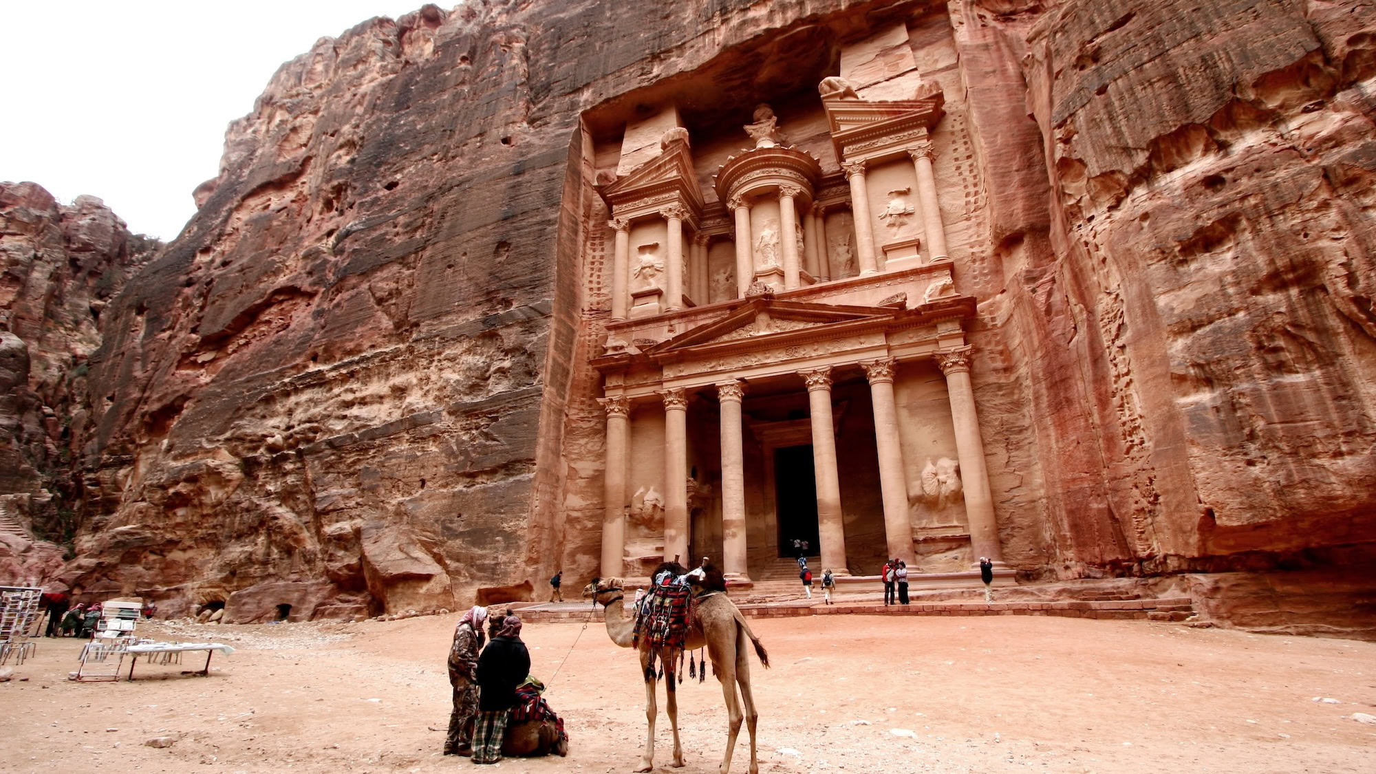 The Treasury (Al-Khazneh) facade at Petra with camels and tourists