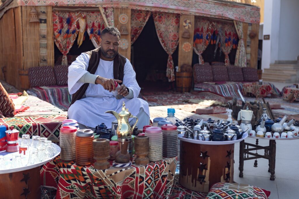 Bedouin preparing and serving traditional tea