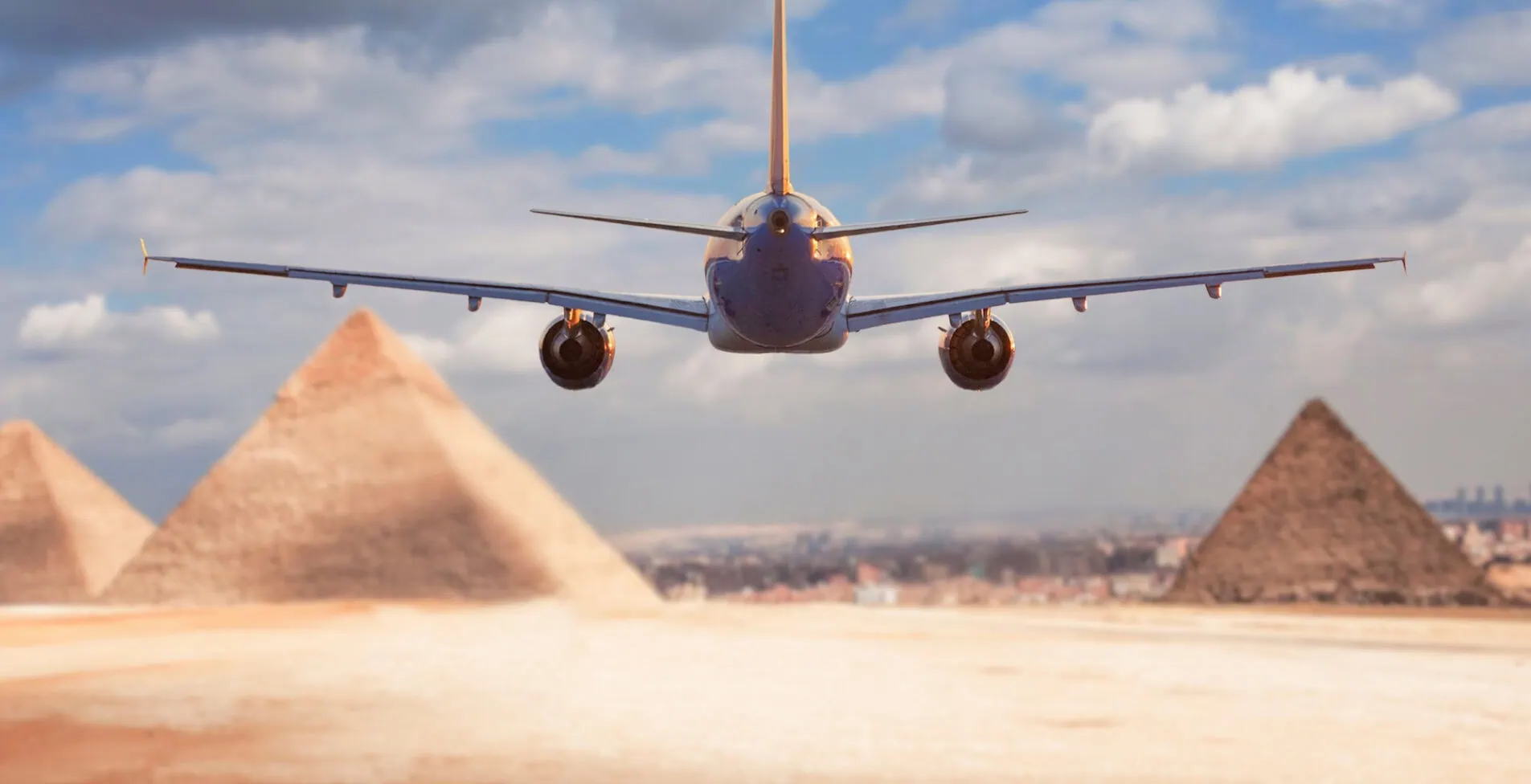 commercial passenger plane flies towards the Giza pyramids concept of travel to Egypt