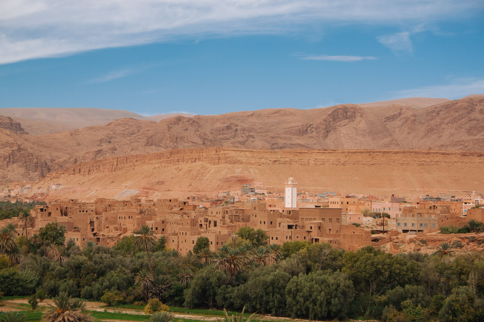 Traditional Berber village in Morocco with adobe buildings and minaret