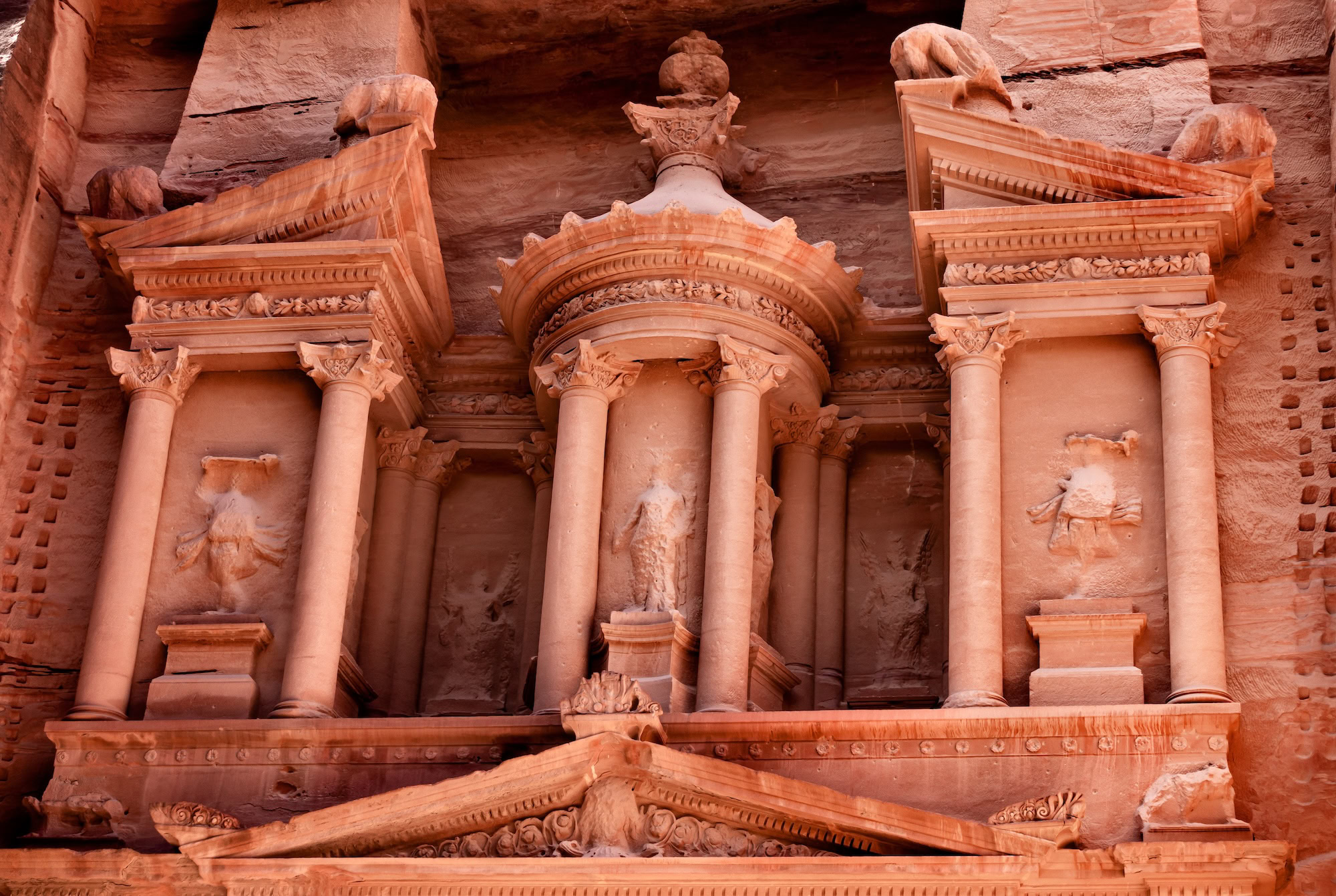 Detailed view of Treasury facade architectural details in Petra showing carved Nabataean stonework