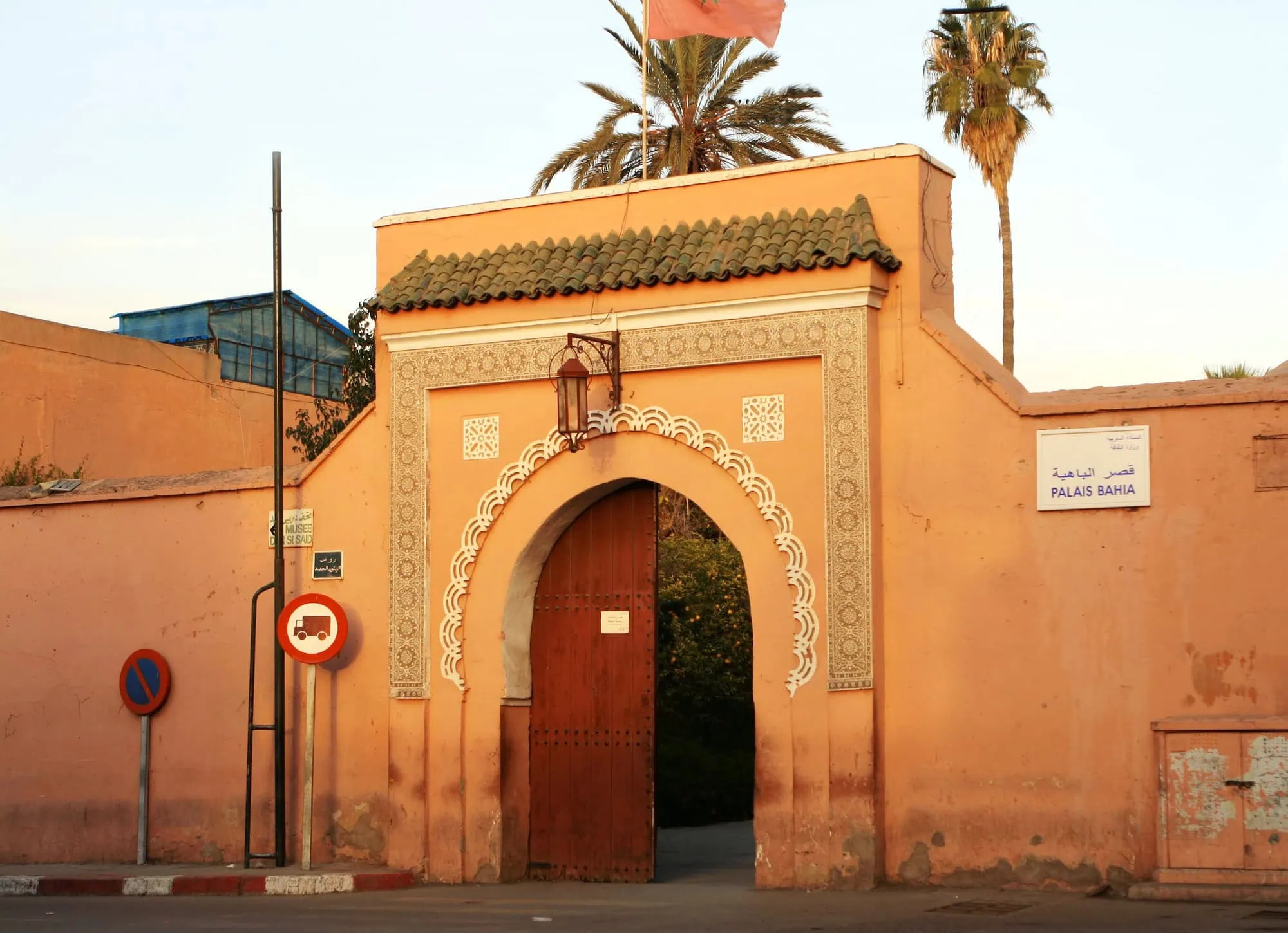 Entrance to Bahia Palace in Marrakech with traditional Moroccan architecture and entrance signage