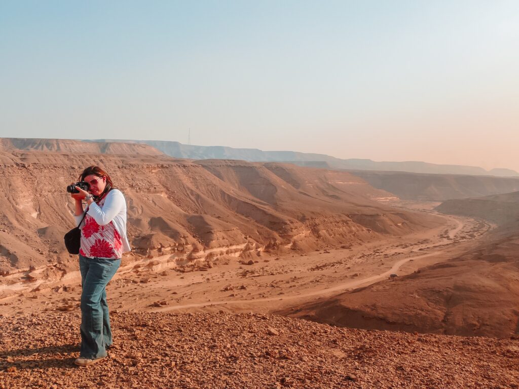 photographer standing on a rocky hill in Wadi Degla Protectorate