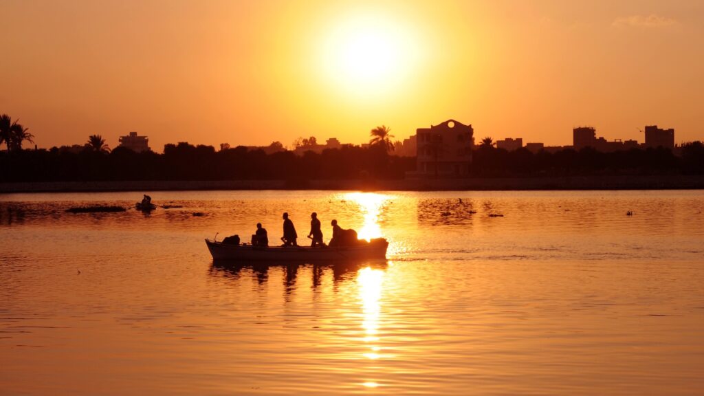 Fishermen in a small boat on the Nile River