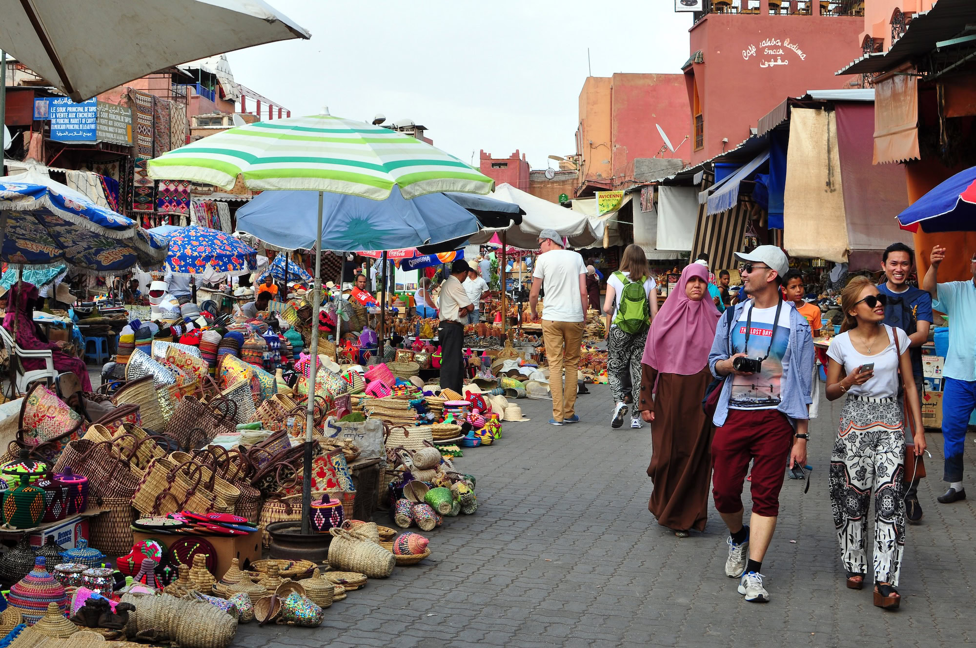 Vibrant traditional Moroccan souk market in Marrakech with colorful textiles and bustling atmosphere