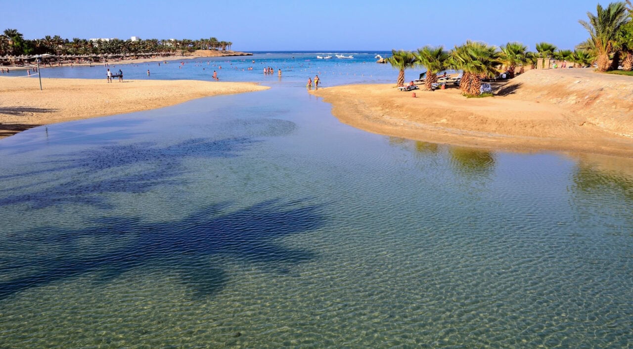 a body of water with people swimming in it
