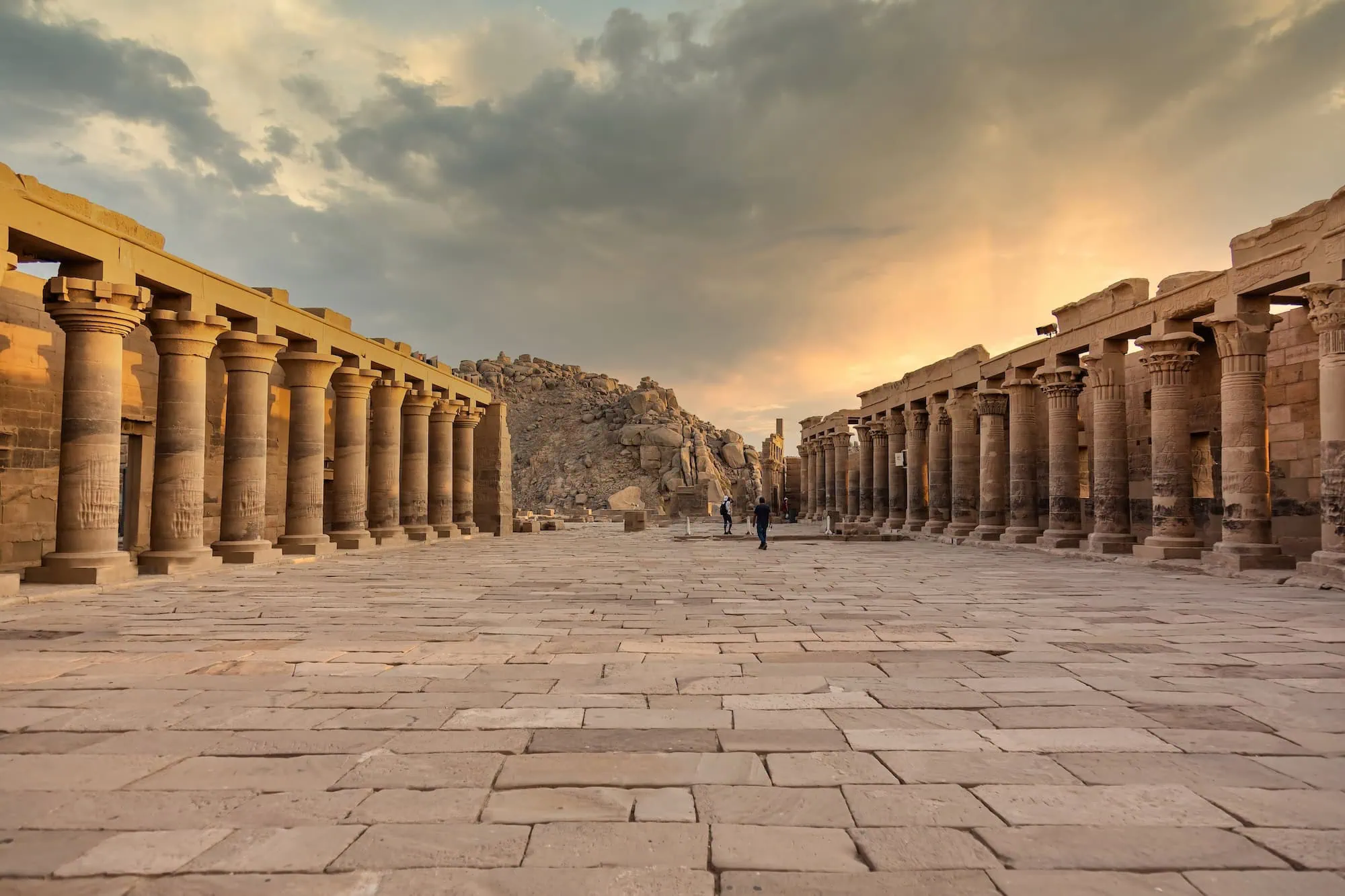 Ancient Philae Temple columns with few tourists in serene setting