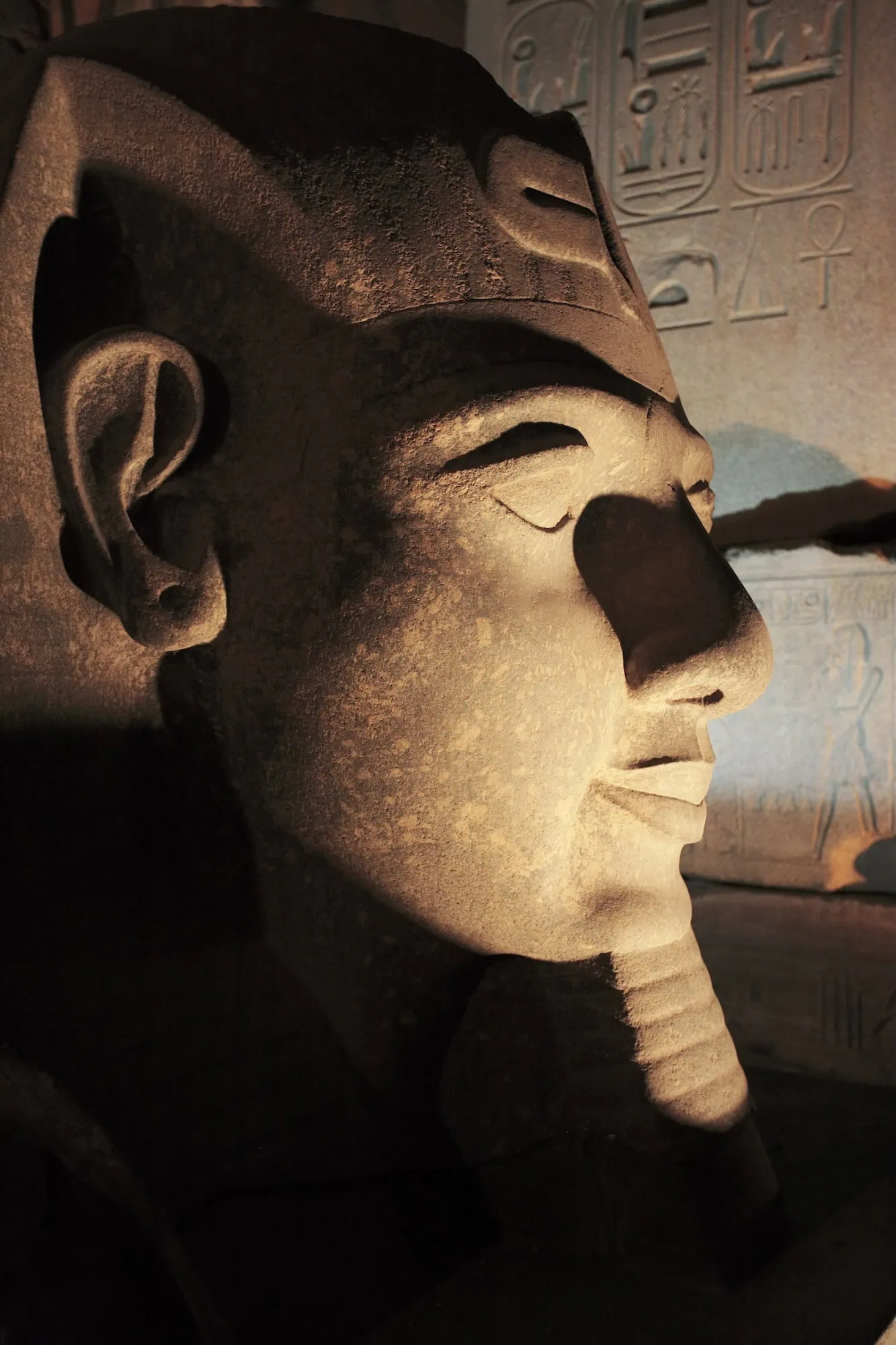 Ancient Egyptian pharaoh statue with hieroglyphics carved in stone