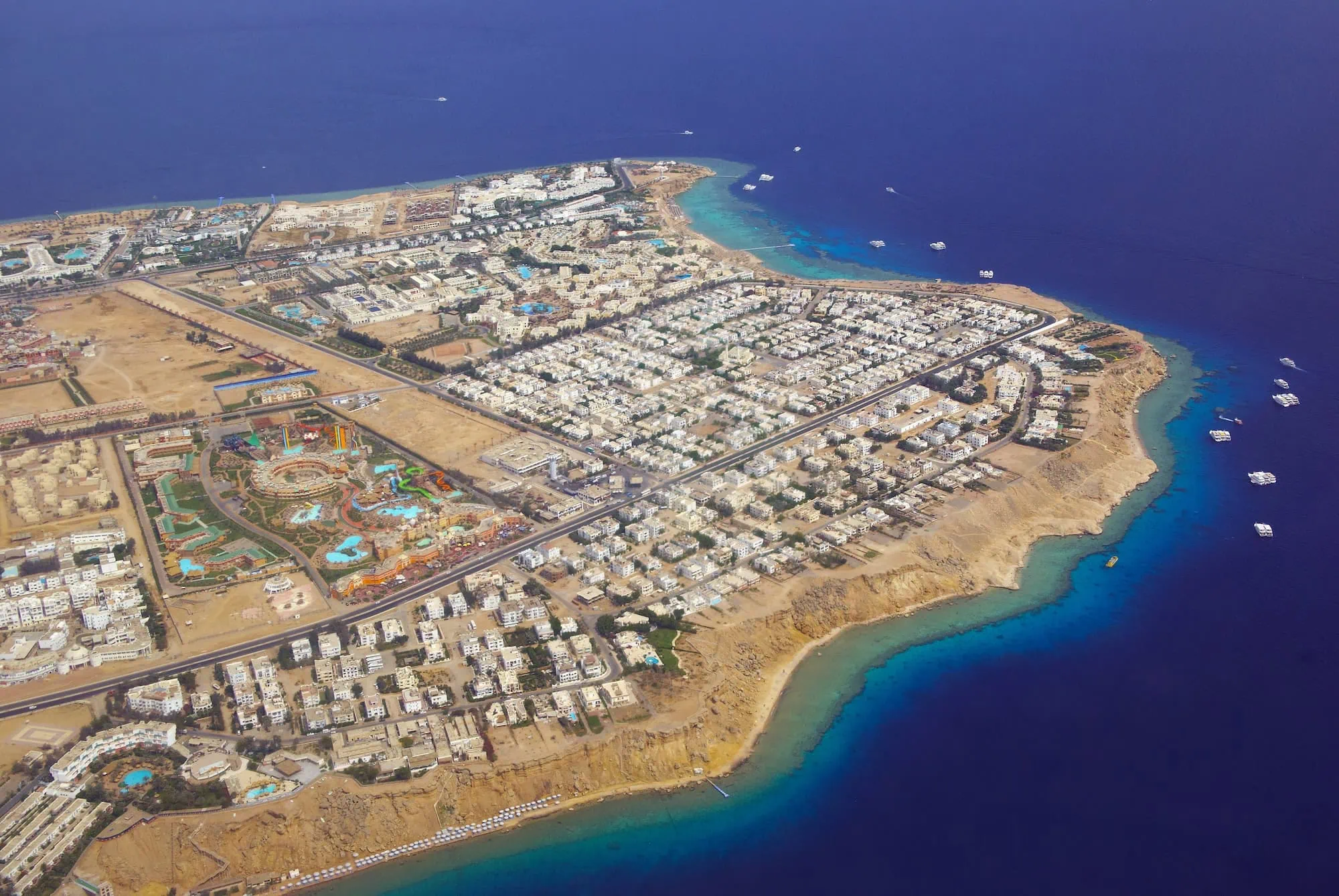 Aerial view of Sharm el-Sheikh resort with pools, hotels, and Red Sea diving access
