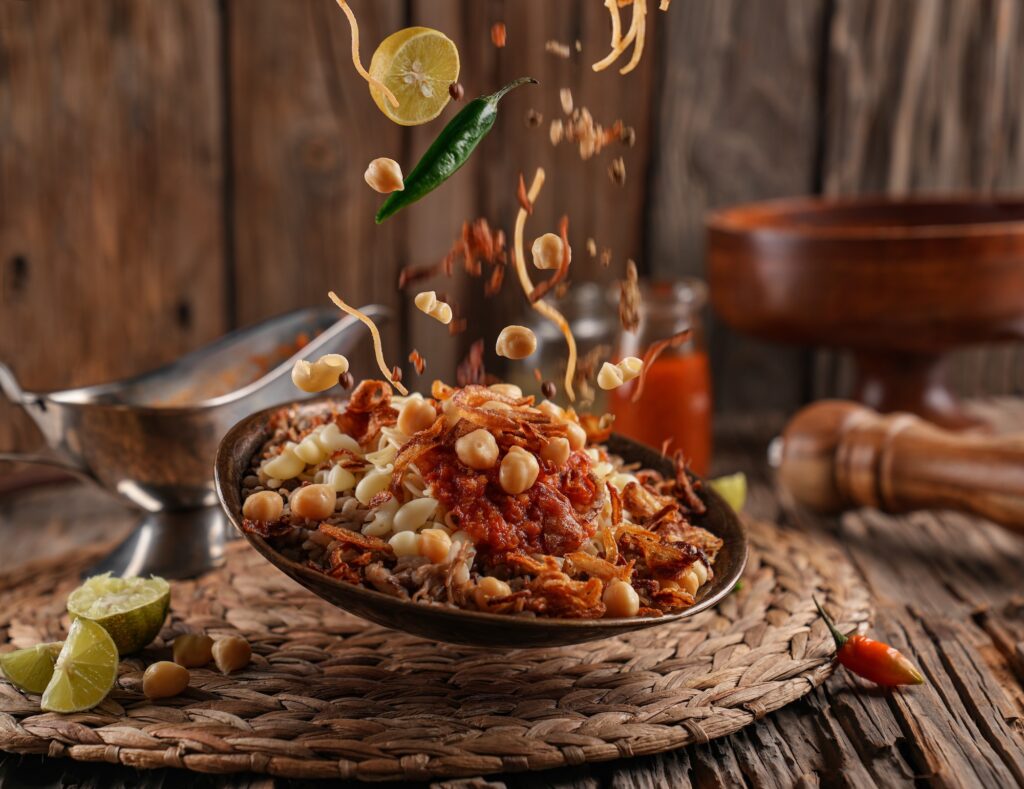 a bowl of food with food falling in the air