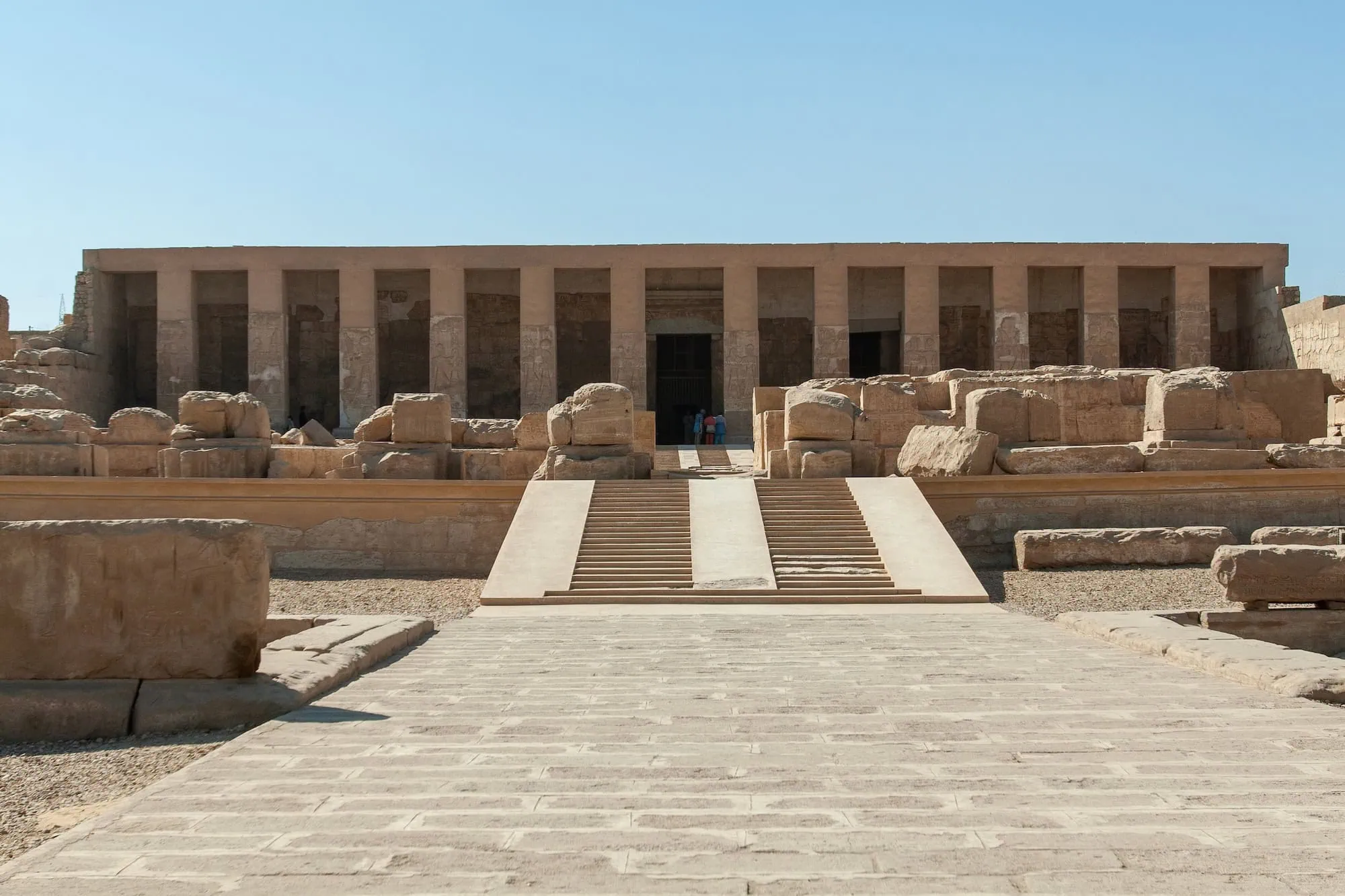 Ancient Abydos Temple courtyard with hieroglyph-covered columns and stone ruins in Egypt