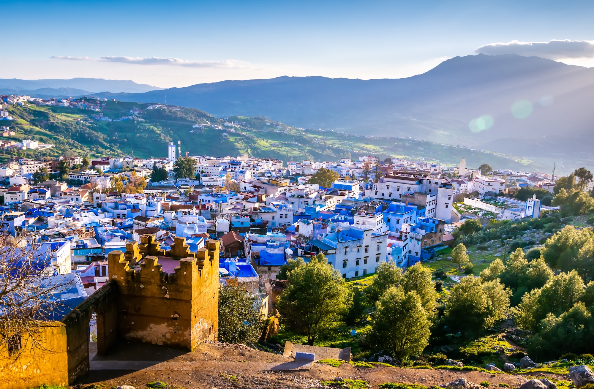 Aerial view of Chefchaouen showing blue-painted buildings spread across mountainous terrain