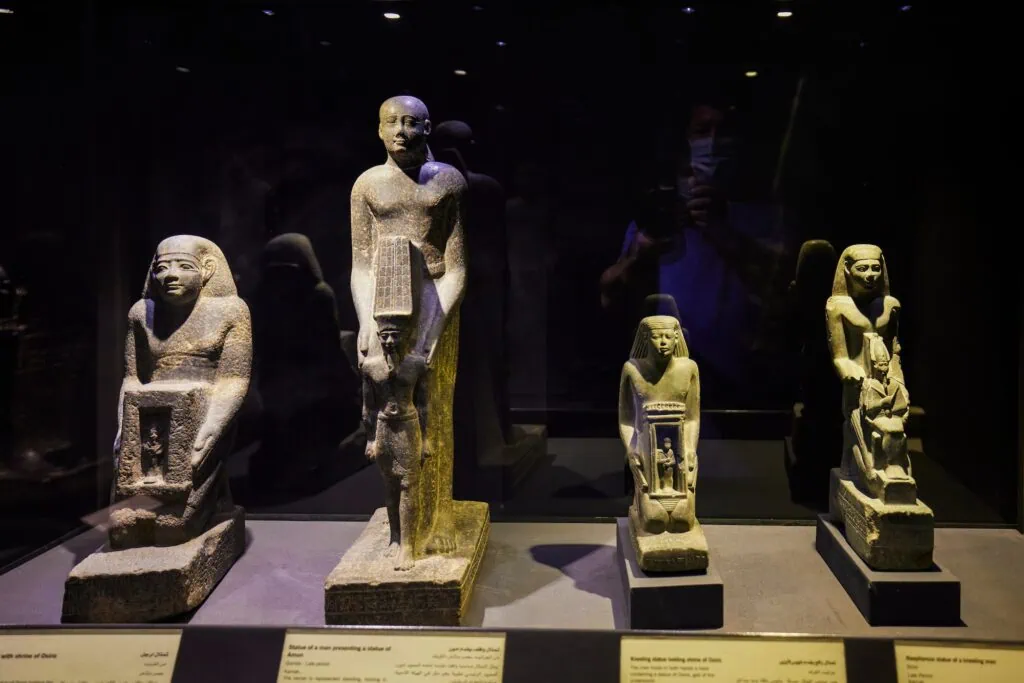 Statues and sculpted figures displayed in glass cases inside the National Museum of Alexandria, Alexandria