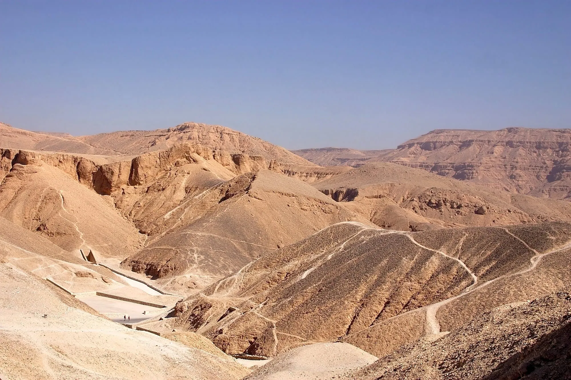 Ancient desert landscape of Valley of the Kings with limestone cliffs and pathways