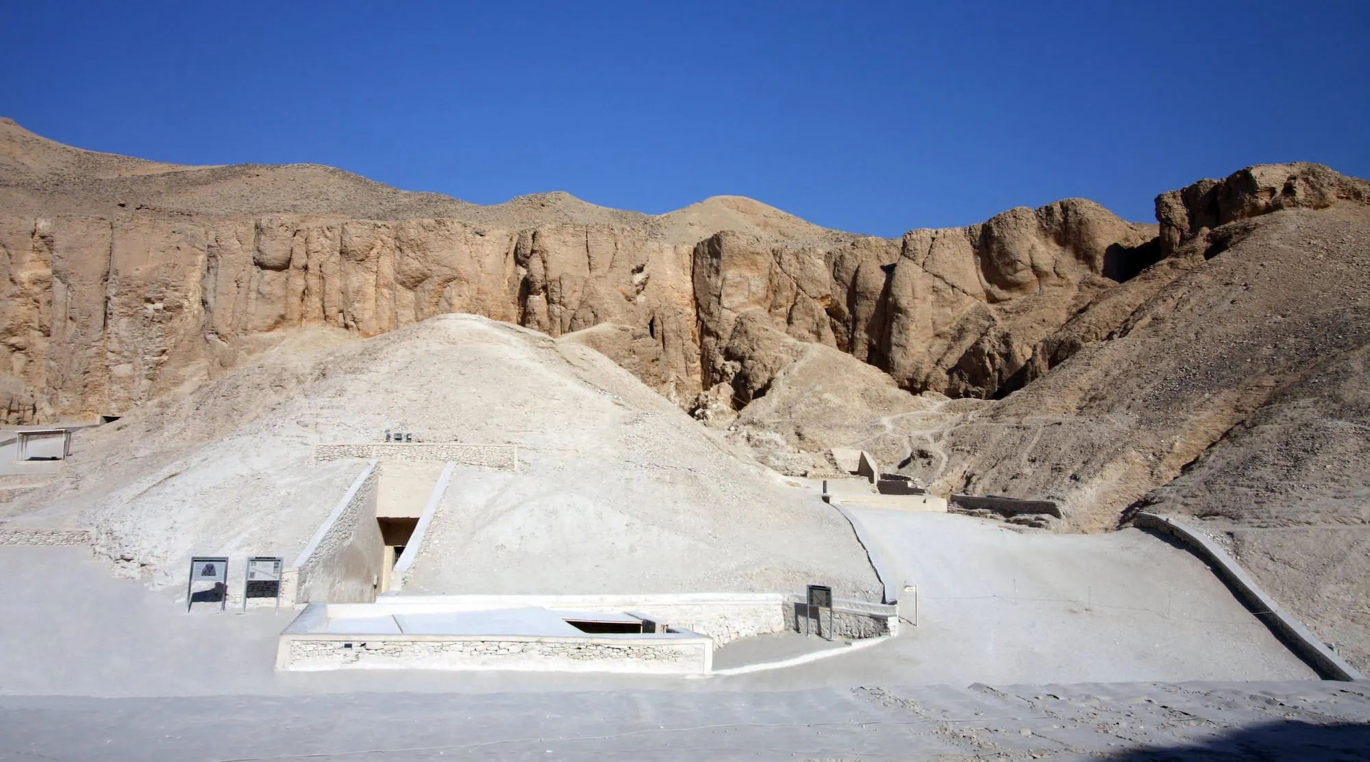 Valley of the Kings tomb entrances with protective covers and wooden walkways for visitor accessibility
