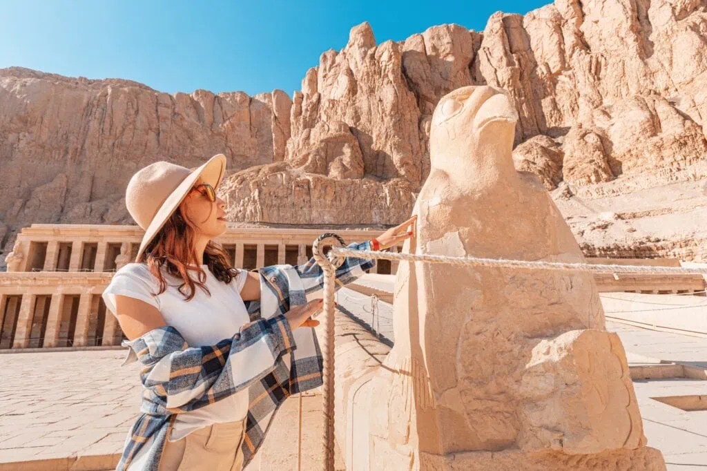 woman traveler explores the ruins of the ancient Egyptian Hatshepsut temple in the heritage city of Luxor