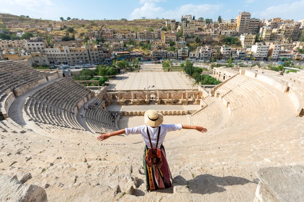 Woman standing in front of the South Roman Theater, Amman, Jordan