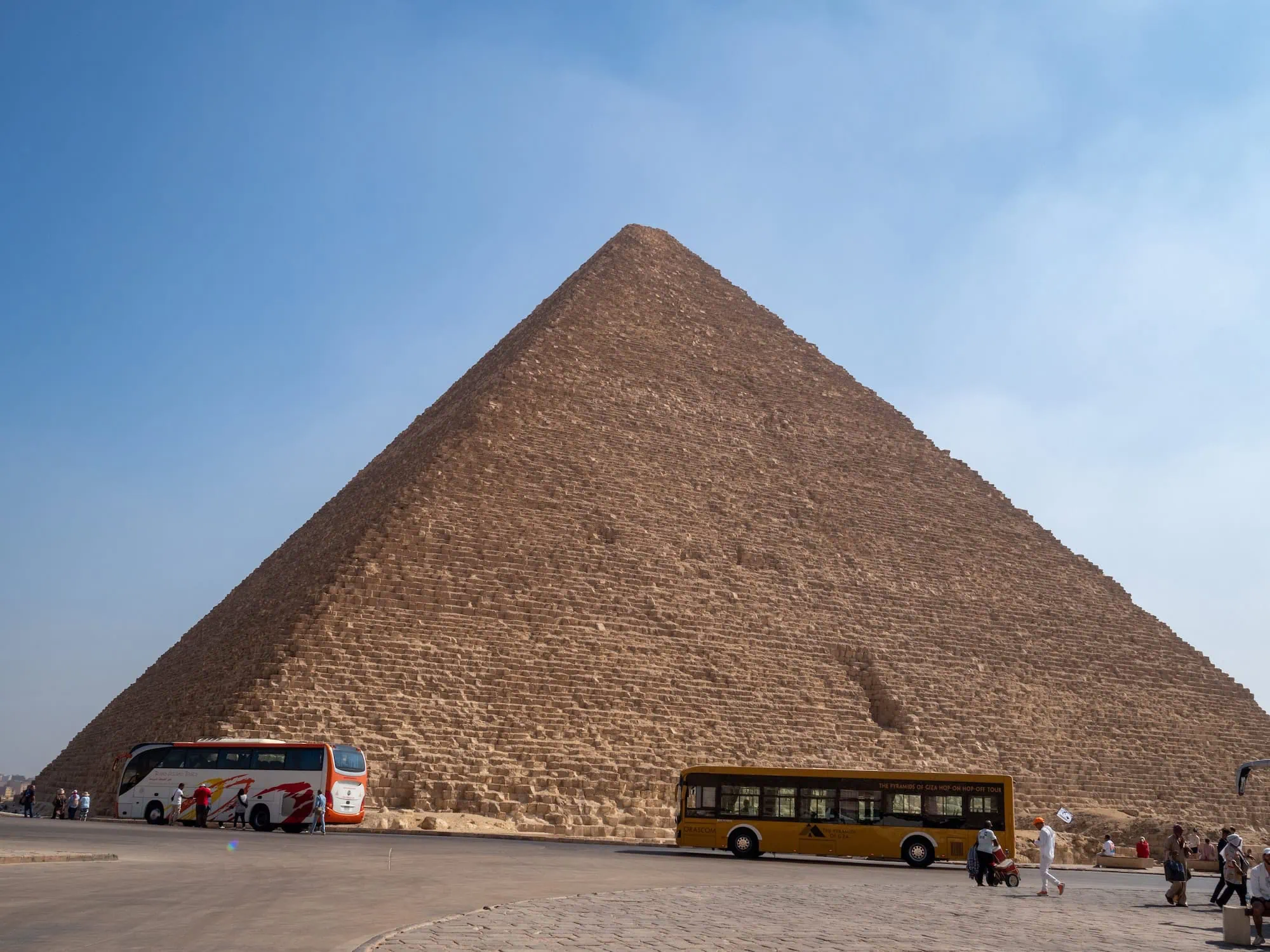 Great Pyramid of Giza with tourist buses and visitors at the entrance